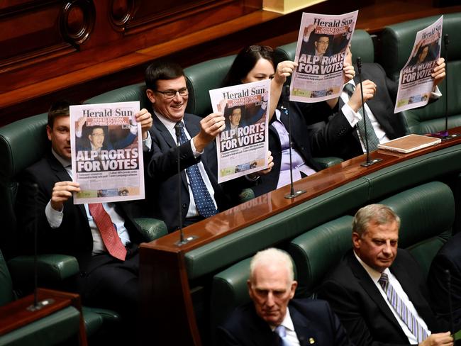 MPs hold up copies of the Herald Sun in Parliament. Picture: Nicole Garmston