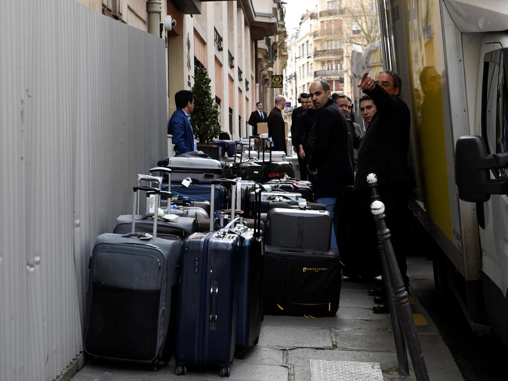 People unload luggage for Saudi Arabia's crown prince Prince Mohammed bin Salman's visiting delegation on April 4, 2018, near the Champs Elysee in Paris.  Saudi Arabia's crown prince Prince Mohammed bin Salman arrived in France on April 8, for the next leg of a global tour aimed at reshaping his kingdom's austere image as he pursues his drive to reform the conservative petrostate. / AFP PHOTO / Eric FEFERBERG