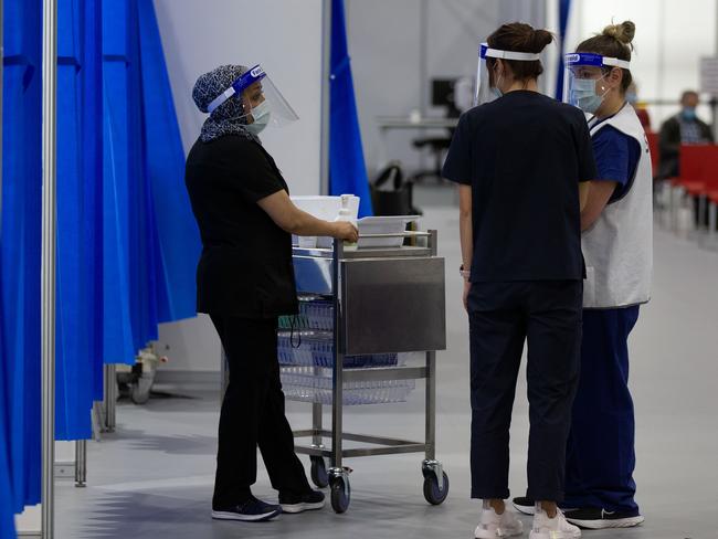 Staff inside the Melbourne Exhibition Centre COVID-19 vaccination centre.