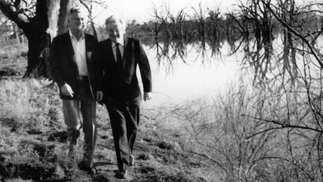 Then prime minister Bob Hawke and then environment minister Graham Richardson on an early-morning stroll along a creek bank near Renmark, SA. Picture: Alan Porritt