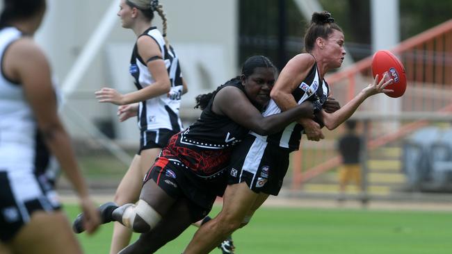 Natasha Medbury is tackled by a Tiwi Bombers forward in the NTFL 22/23 season opener. Picture: (A)manda Parkinson