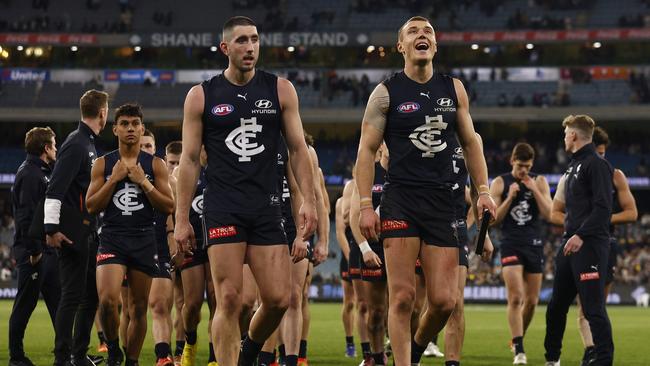 Jacob Weitering and Patrick Cripps walk off the MCG on Sunday. Picture: Daniel Pockett/Getty Images