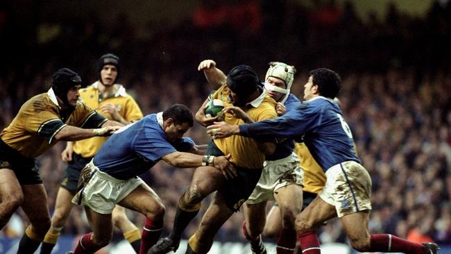 Toutai Kefu of Australia is tackled by Christophe Lamaison and Marc Lievremont of France during the Rugby World Cup Final, 1999. Mandatory Credit: Ross Kinnaird /Allsport