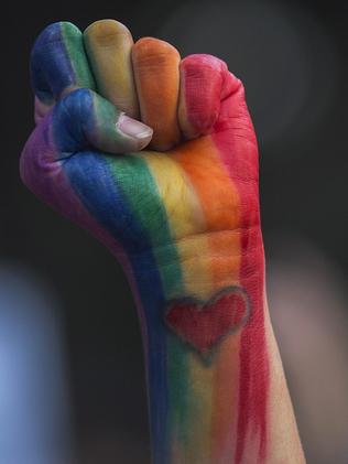 A defiant fist is raised at a vigil for the worst mass shooing in United States history. Picture: AFP