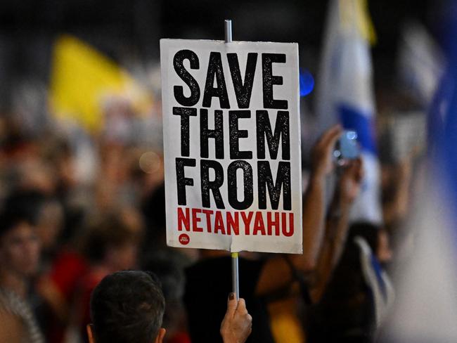 TEL AVIV, ISRAEL - OCTOBER 5: A sign reading "Save Them From Netanyahu" is held by a protester on October 5, 2024 in Tel Aviv, Israel. Anti-government protests have been a recurring feature of Saturday nights in Tel Aviv since shortly after the Oct. 7 attack last year. Today's protest was officially limited to 1000 people due to the Home Front Command's orders, prompted by threats of rockets, but the estimated crowd size quickly exceeded that. (Photo by Leon Neal/Getty Images)