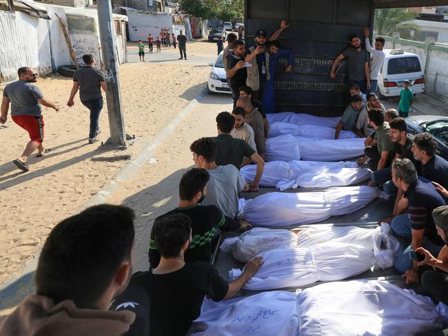 Mourners gather around the shrouded bodies of members of the Agha family, killed in an Israeli strike in Khan Yunis in the Gaza Strip. Picture: AFP