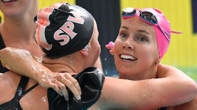 Emma McKeon (right) hugs Ariarne Titmus after winning the 200m freestyle final. Picture: AAP