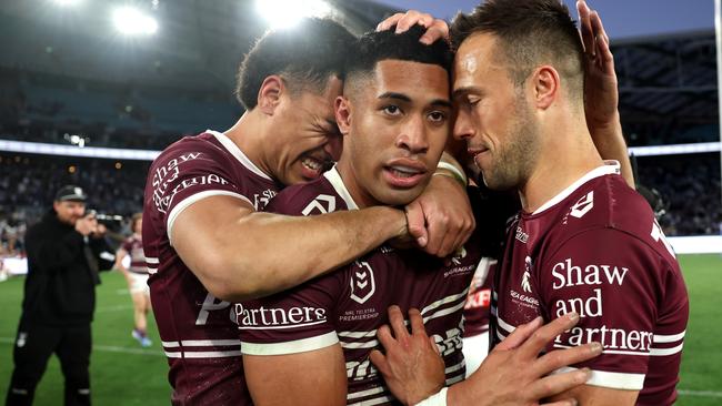 SYDNEY, AUSTRALIA - SEPTEMBER 15: Lehi Hopoate of the Sea Eagles, Tolutau Koula of the Sea Eagles and LukeÃÂ Brooks of the Sea Eagles embrace after winning during the NRL Qualifying Final match between Canterbury Bulldogs and Manly Sea Eagles at Accor Stadium on September 15, 2024 in Sydney, Australia. (Photo by Cameron Spencer/Getty Images)