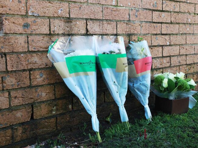 Flowers have been left for victims of an inferno in Sydney's south west.