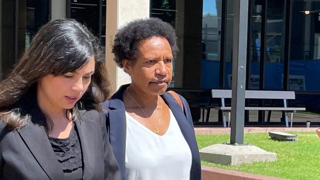 Dr Mary Anderson (white shirt) leaves the Cairns courthouse complex on August 16 after giving evidence at a coronial inquest into the rheumatic fever deaths of three Doomadgee women in 2019 and 2020. Picture: Peter Carruthers