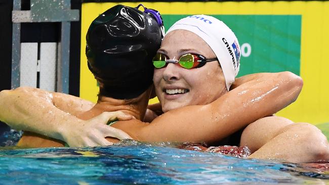 Emma McKeon hugs sprint legend Cate Campbell (right) after both booked tickets for Tokyo following their one-two in the 100m freestyle final in Adelaide. Picture: Getty Images