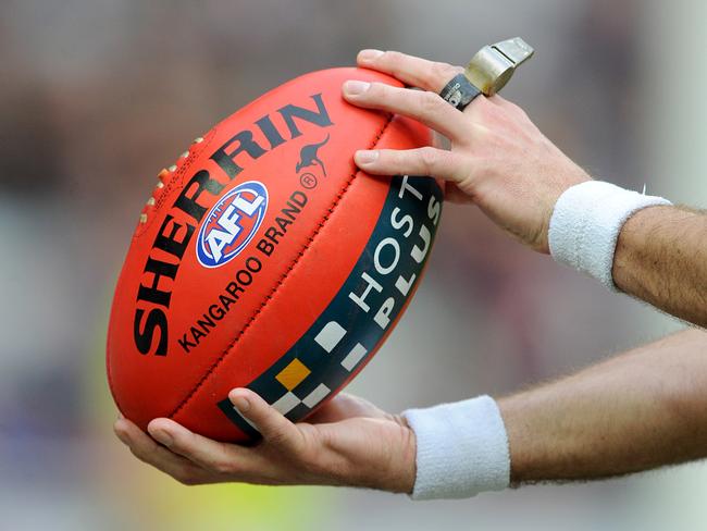 Generic image of the umpire holding the ball, during the Round 16 AFL match between the Richmond Tigers and the Brisbane Lions at the MCG in Melbourne, Saturday, July 5, 2014. (AAP Image/Joe Castro) NO ARCHIVING, EDITORIAL USE ONLY