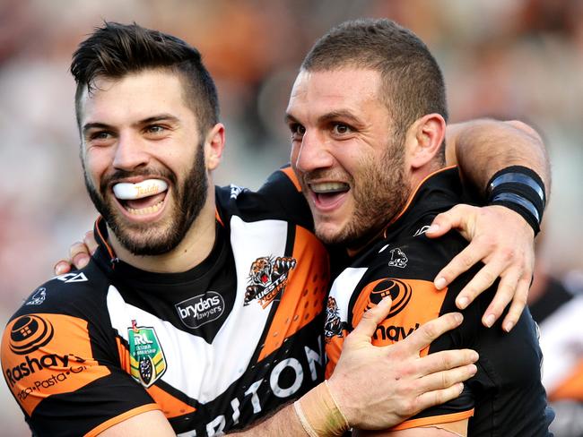 Tigers James Tedesco and Robbie Farah celebrate Tigers Martin Taupau scoring a try during the NRL game between the Wests Tigers and the New Zealand Warriors at Campbelltown Stadium , Campbelltown.Picture Gregg Porteous