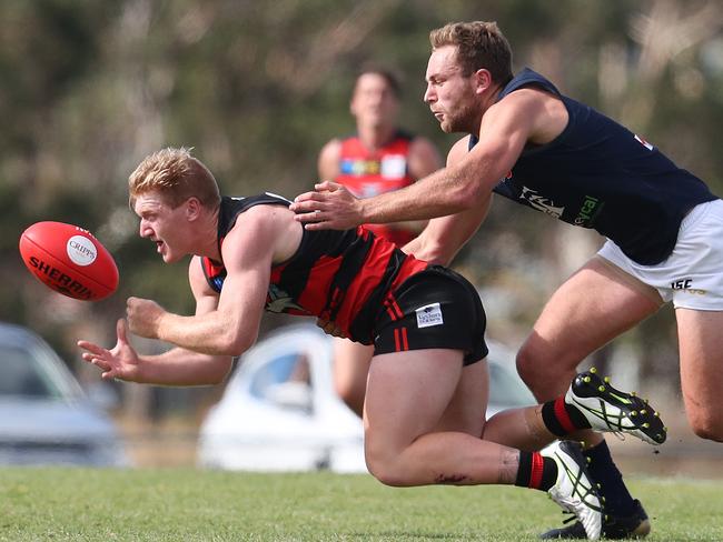 Bryce Walsh clears the ball under pressure from Launceston’ Jobi Harper. Picture: NIKKI DAVIS-JONES