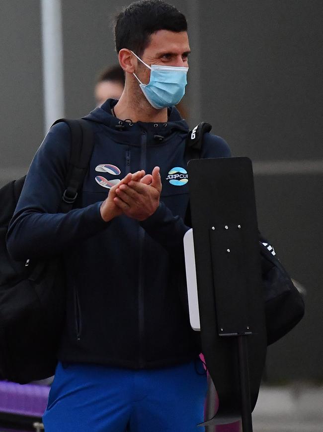 Novak Djokovic sterilises his hands as he arrives at Adelaide Airport. Picture: Mark Brake/Getty Images