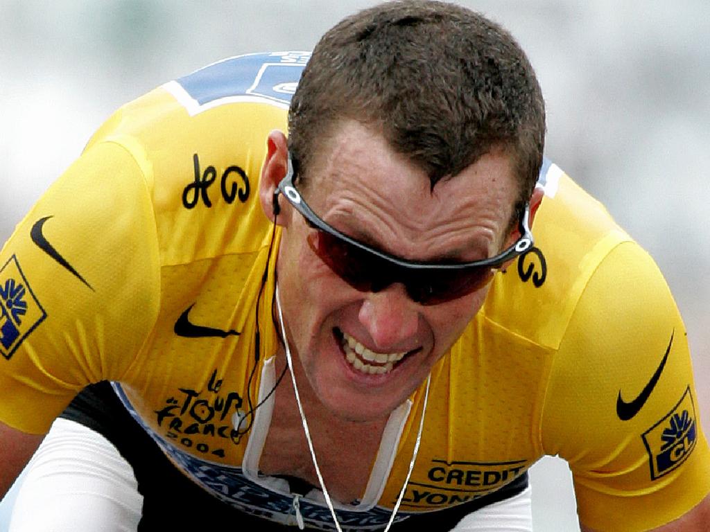 Yellow jersey leader Lance Armstrong powers on during the 2004 Tour de France stage 16 mountain time trial from Bourg d'Oisans to L'Alpe d'Huez. Armstrong was the only rider to complete the stage in under 40 minutes, thus securing his 21st yellow jersey. | Location: Bourg d'Osians, France. (Photo by Tim de Waele/Corbis via Getty Images)
