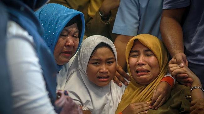 Family members of the crashed Indonesian plane react at Pangkal Pinang airport. Picture: AFP