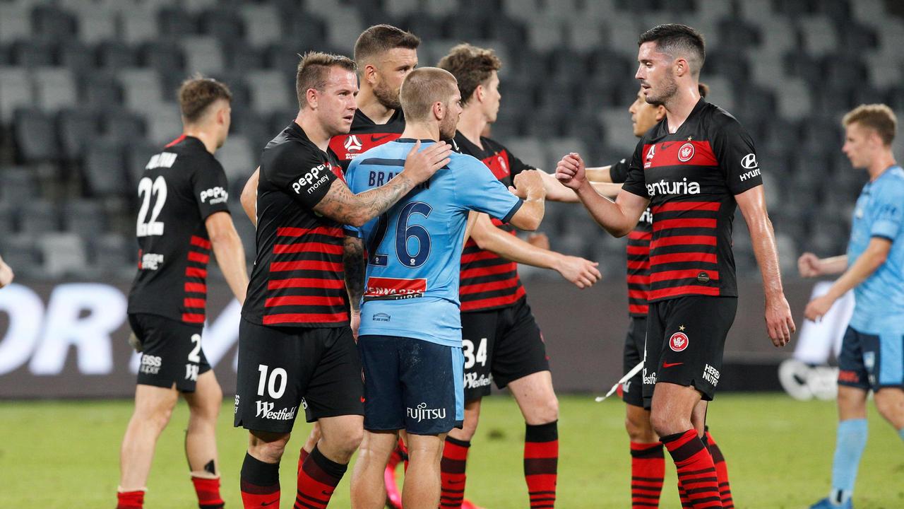 Players fist-bump at an empty stadium before the A-League was suspended.