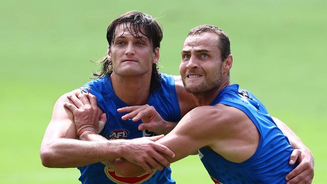 GOLD COAST, AUSTRALIA - APRIL 04: Ned Moyle and Jarrod Witts compete for the ball during a Gold Coast Suns AFL training session at People First Stadium on April 04, 2024 in Gold Coast, Australia. (Photo by Chris Hyde/Getty Images)