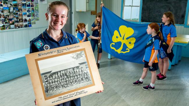 Shikirra Earle poses for a photograph at Sandgate Guides for their 90th anniversary along with other current Girl Guides. PICTURE: AAP/Richard Walker.