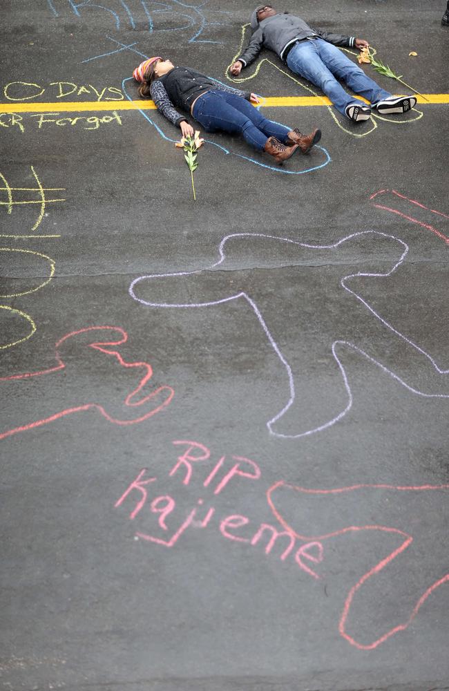 The people versus the state ... Demonstrators lay on the ground in a mock death protest of the shooting death of Michael Brown by a Ferguson police officer in St. Louis, Missouri. Source: AFP