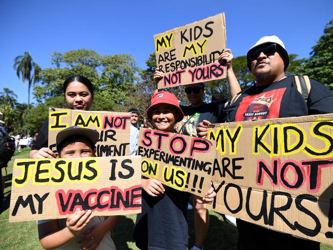 BRISBANE, AUSTRALIA - NewsWire Photos - AUGUST, 21, 2021A family holds signs as people gather for a protest to rally for freedom of speech, movement, choice, assembly, and Health in Brisbane. Picture: NCA NewsWire / Dan Peled