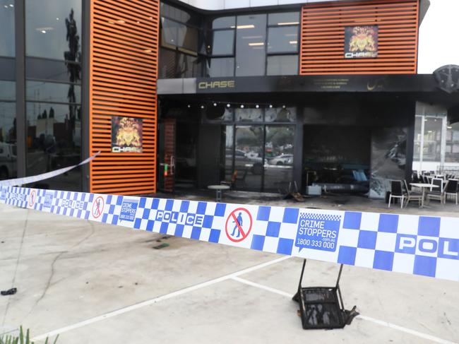 Police tape surrounds the burnt-out restaurant. Picture: David Crosling