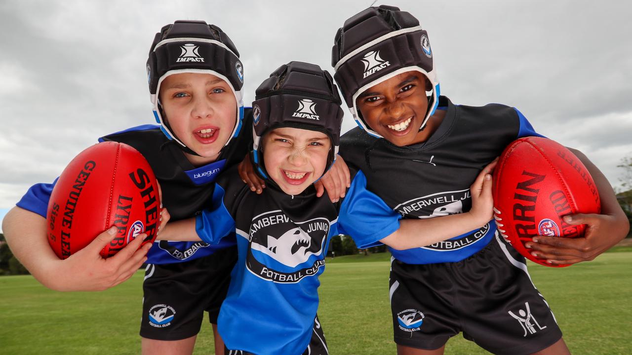 Helmets are mandatory for Camberwell Sharks Junior Football Club players like Toby, 11, Tessa, 8, and Aryan, 11. Picture: Alex Coppel