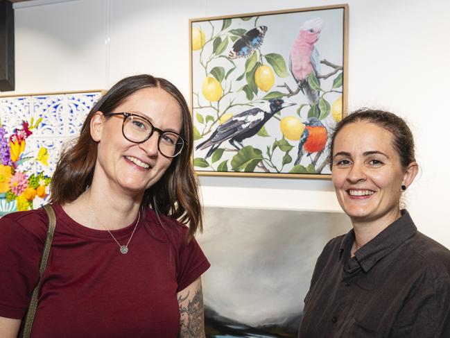 The Next Big Thing finalist Teneille Grace (left) with wife Karlie Grace and her work Conversations With Friends (centre) at The Toowoomba Gallery, Friday, March 1, 2024. Picture: Kevin Farmer