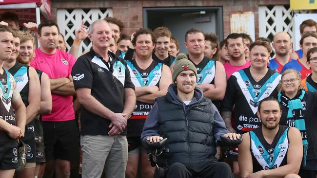 Ryan Wiggins with L-R Phil Smith committee member from the build team and Thor Boscott playing coach of Cygnet at the cheque presentation for $579,506.39 from the sale of the house that build at Cygnet to raise funds for Ryan Wiggins. Picture: Carolyn Whitehouse