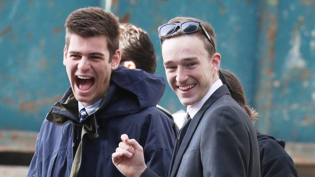 Theodore Burns (right, foreground) leaves Downing Centre Local Court after his sentence for drunkenly crashing into multiple cars.