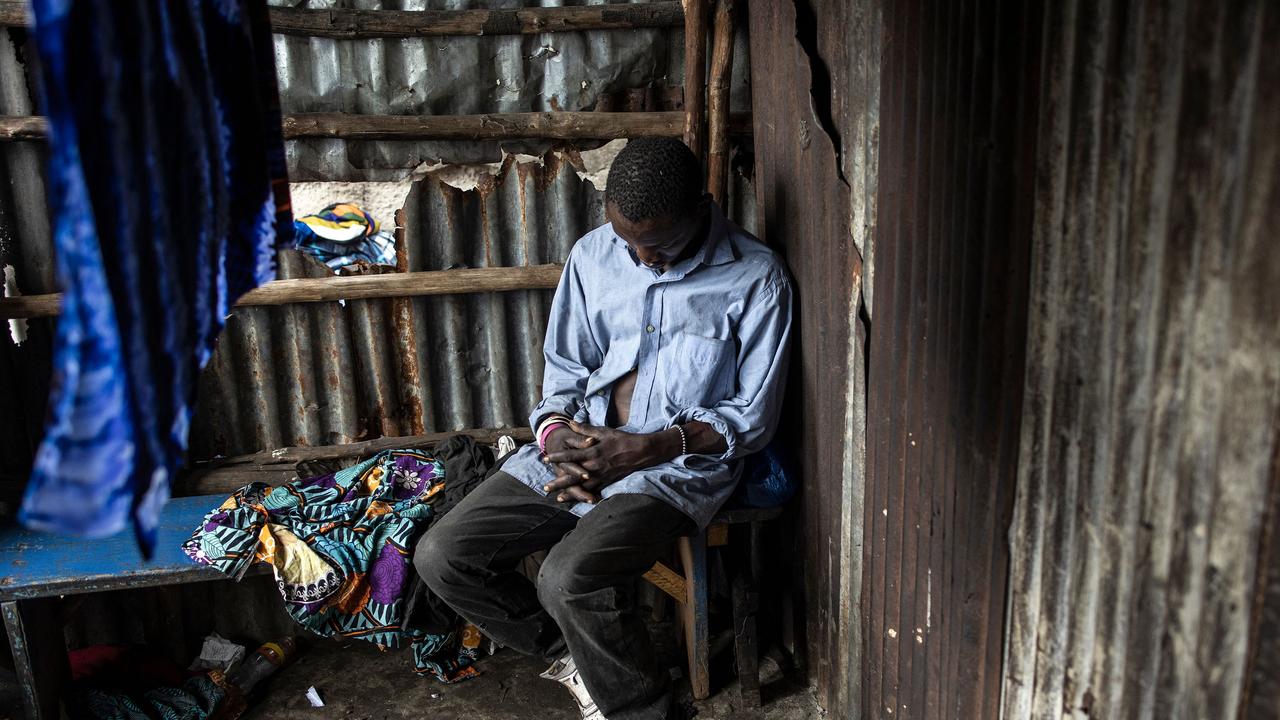 A man sleeps inside a drug den at the Kington landfill site in Freetown. Picture: John Wessels / AFP