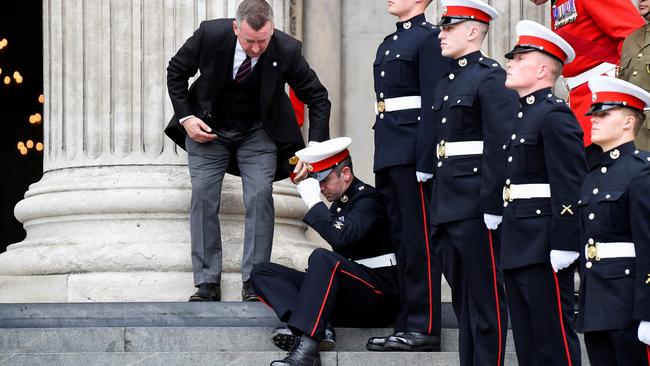 The soldier takes a moment to steady himself. Picture: Toby Melville/Getty Images