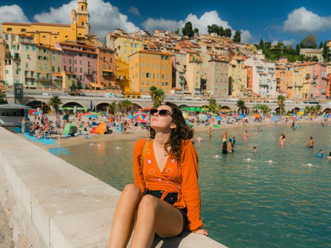 Woman walking in Menton town during her vacation in French Riviera