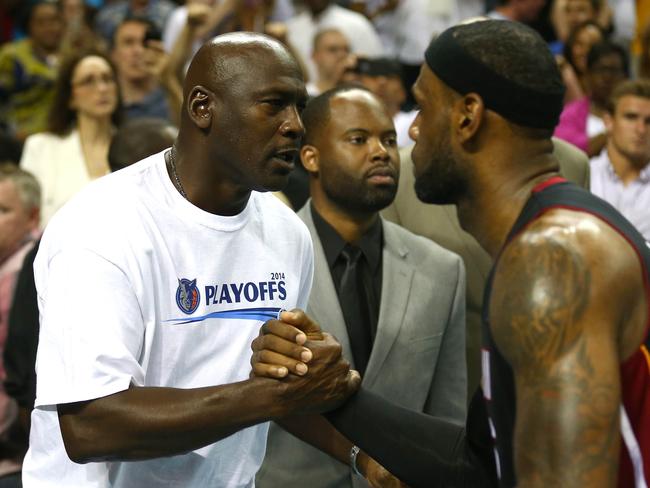 Modern-day superstar LeBron James greets Michael Jordan.