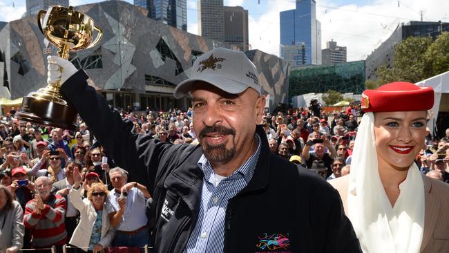 Marwan Koukash lifts the Melbourne Cup up for the fans at Federation Square in Melbourne.