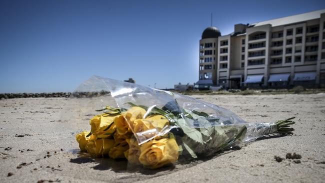 A floral tribute left on the sand for the teenage girl who drowned. Picture: AAP/Mike Burton