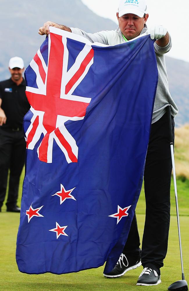 Former Australian cricketer Ricky Ponting lays out the New Zealand flag for New Zealand Prime Minister John Key to wear during day four of the 2016 New Zealand Open at The Hills in Queenstown, New Zealand, earlier this month. Picture: Hannah Peters / Getty Images