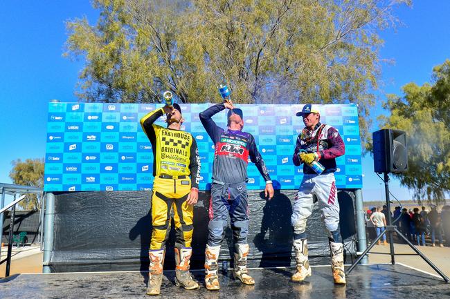 Jacob Smith (2nd), David Walsh (1st) and Beau Ralston (3rd) celebrate after the 2019 Tatts Finke Desert Race. Pic: MATT HENDERSON