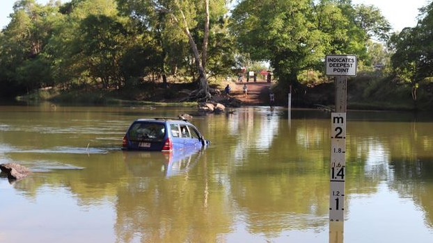 People travelling in this now waterlogged Subaru had to be rescued overnight when it became stuck at Cahills Crossing. Picture: Charlotte Ruth