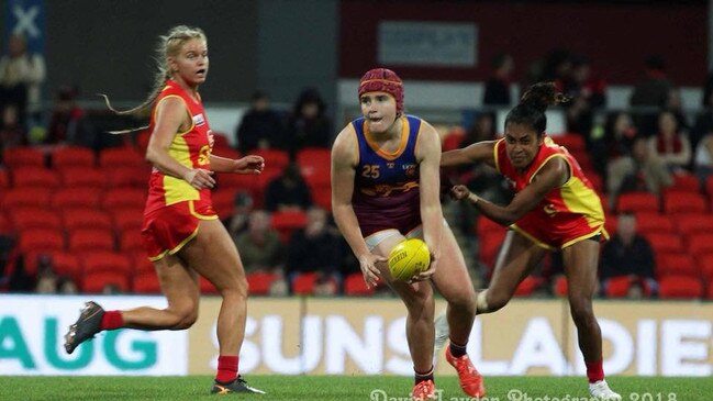 Jessi Henning (middle) playing for the Lions in an academy game against the Suns.