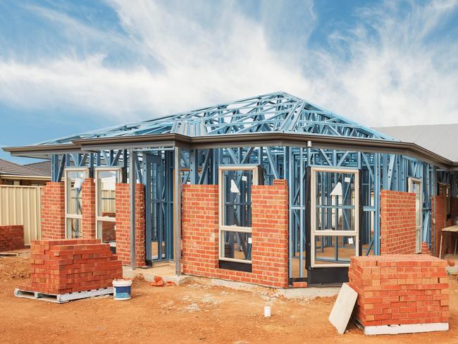 New residential construction home from brick with metal framing against a blue sky; real estate Australian generic suburban homes