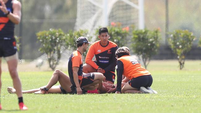 Dylan Shiel is attended to by GWS trainers. Picture: Brett Costello