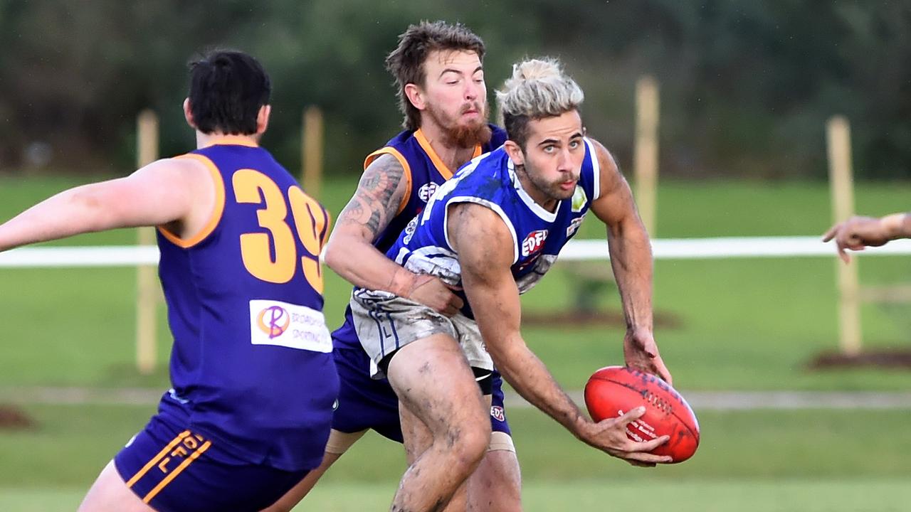 Essendon District: Coburg Districts’ Jacob Kerin gets a handball away under pressure. Picture: Steve Tanner