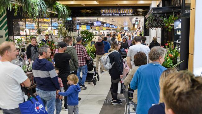 A long line of customers waits to enter Foodland at Pasadena on Saturday. Photo: Brenton Edwards.