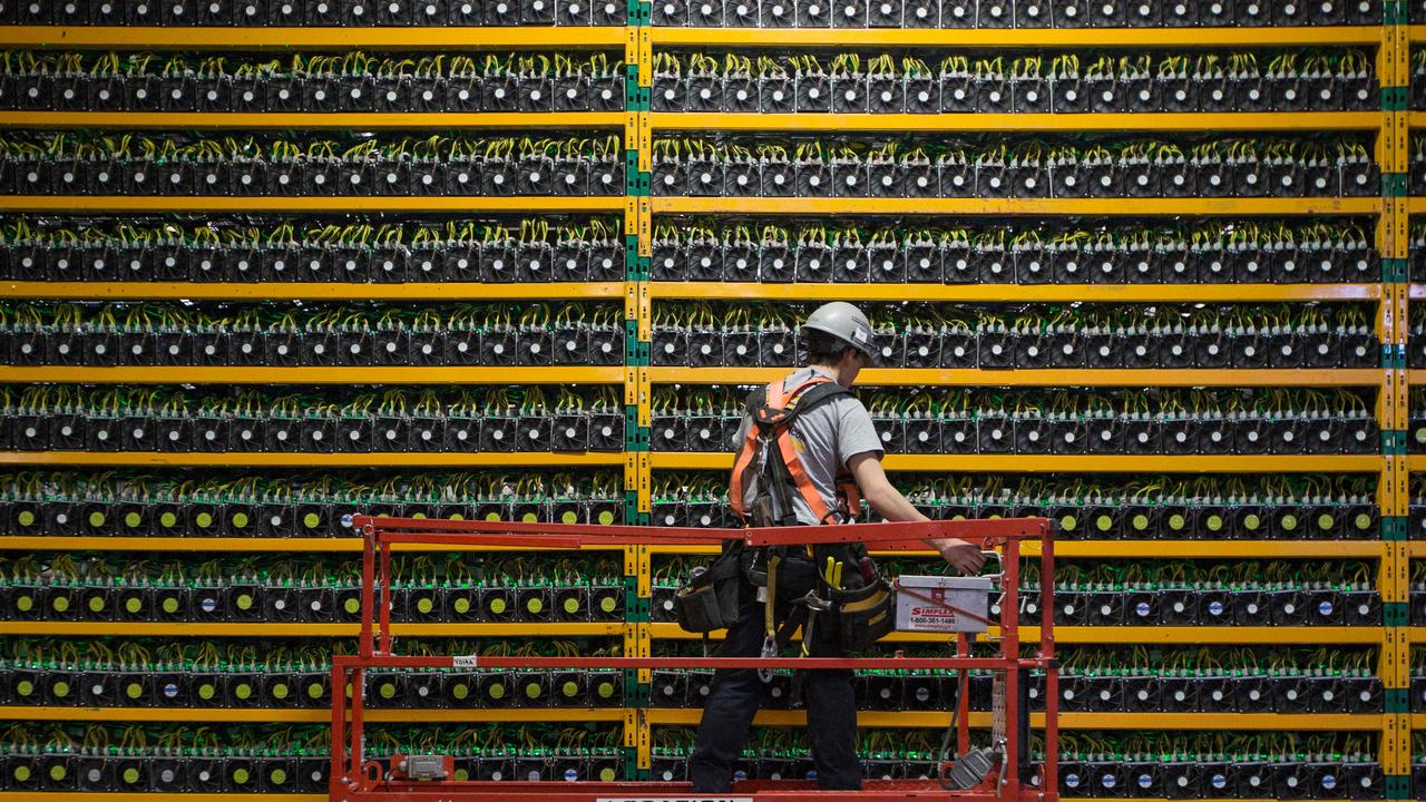 A technician inspects the backside of bitcoin mining at Bitfarms in Saint Hyacinthe, Quebec. Picture: Lars Hagberg/AFP