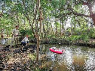 Queensland Department of Environment and Science officers from the water quality and investigations team gathering results from water quality monitoring sensors. Picture: Contributed