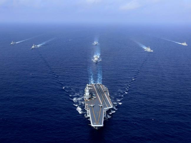 (FILES) In this file photo taken on April 18, 2018, China's operational aircraft carrier, the Liaoning, sails during a drill at sea. - During Xi Jinping's decade-long rule China has built the world's largest navy, revamped the world's largest standing army and amassed a nuclear and ballistic arsenal to trouble any foe. (Photo by AFP) / China OUT / TO GO WITH China-Xi-congress-military-Asia Pacific, FOCUS by Andrew BEATTY