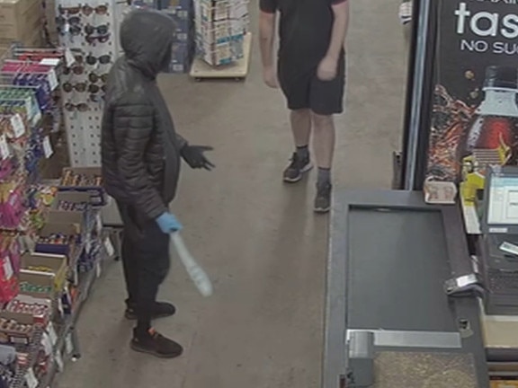 A store worker being threatened with a machete in Werribee. Picture: Supplied.