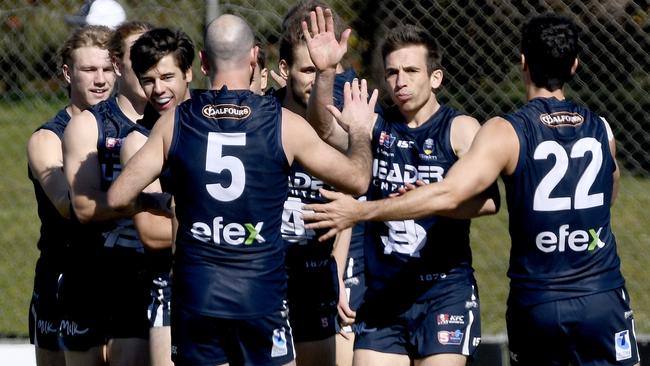 South Adelaide teammates congratulate Joel Cross on a goal. Picture: Naomi Jellicoe